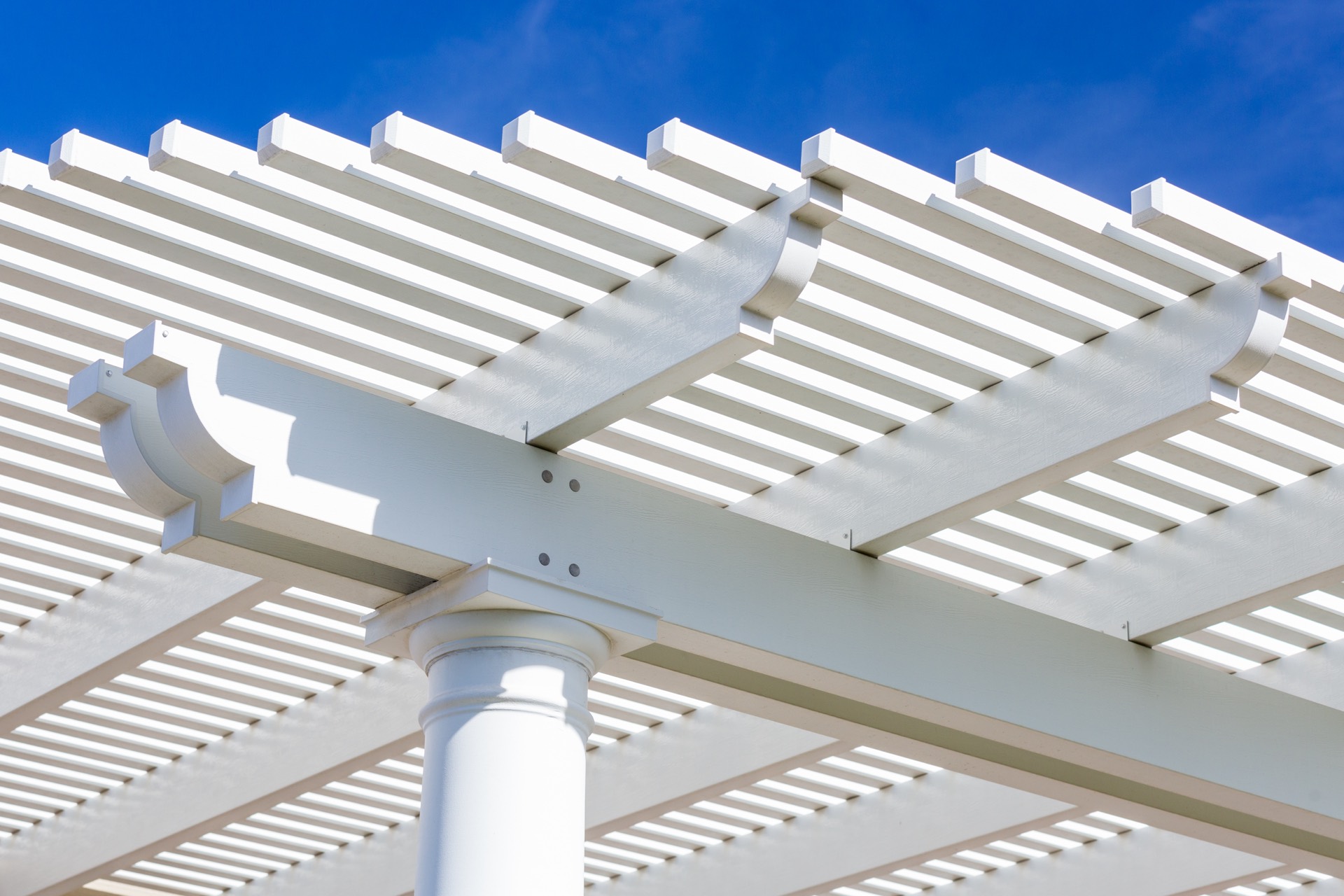 Covered patio with a modern pergola over an outdoor living area